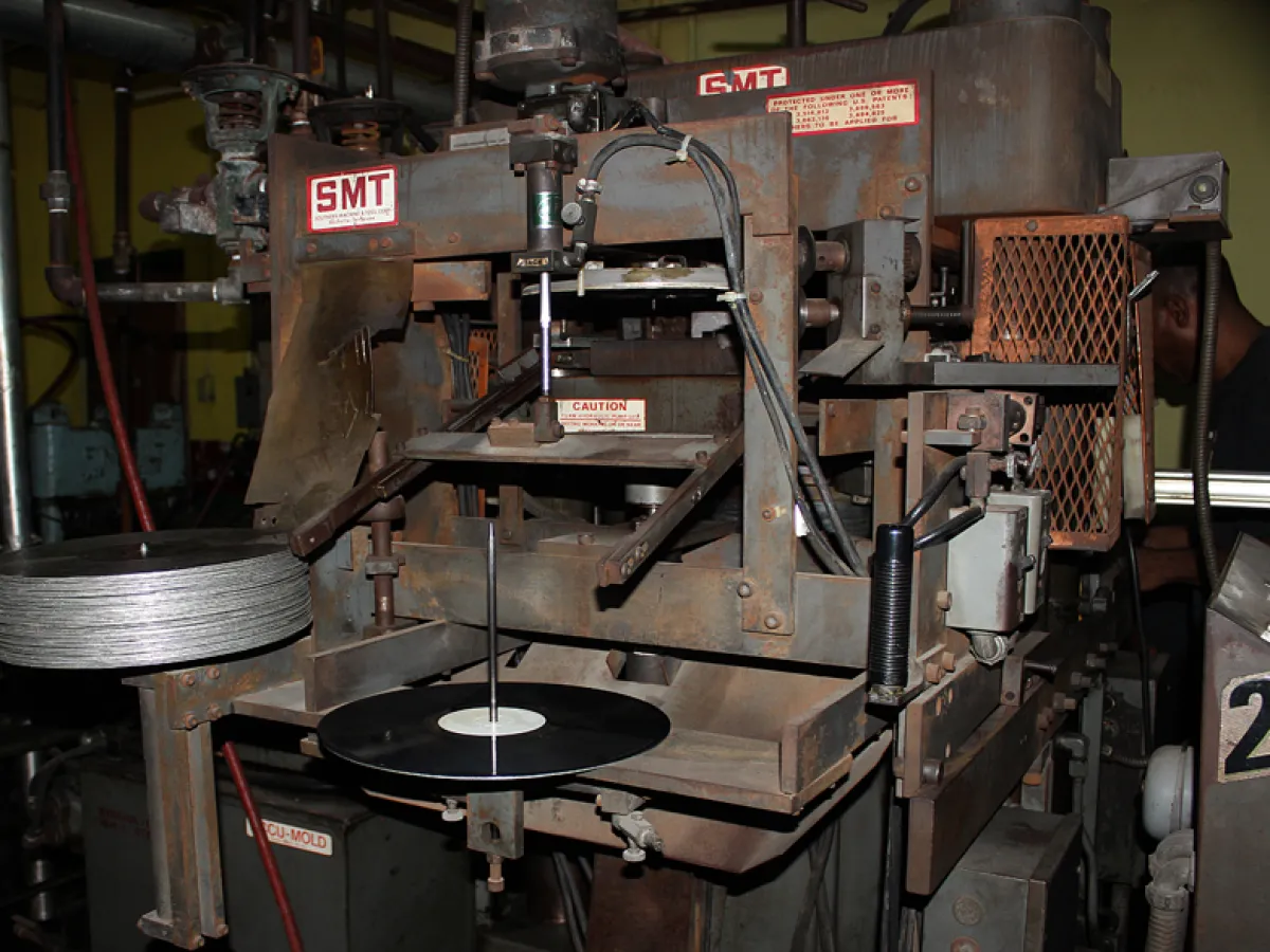 An overlook at a vinyl pressing machine at Tuff Gong