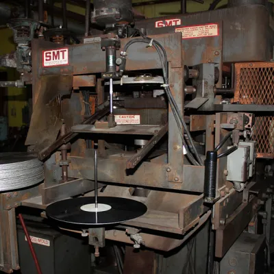 An overlook at a vinyl pressing machine at Tuff Gong