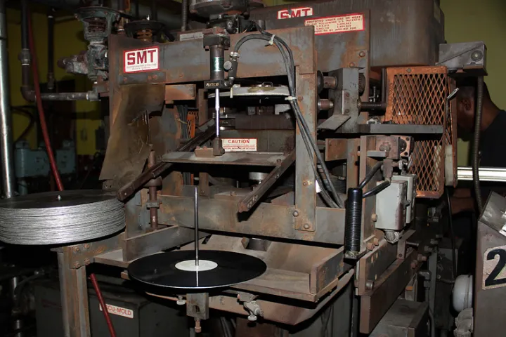An overlook at a vinyl pressing machine at Tuff Gong