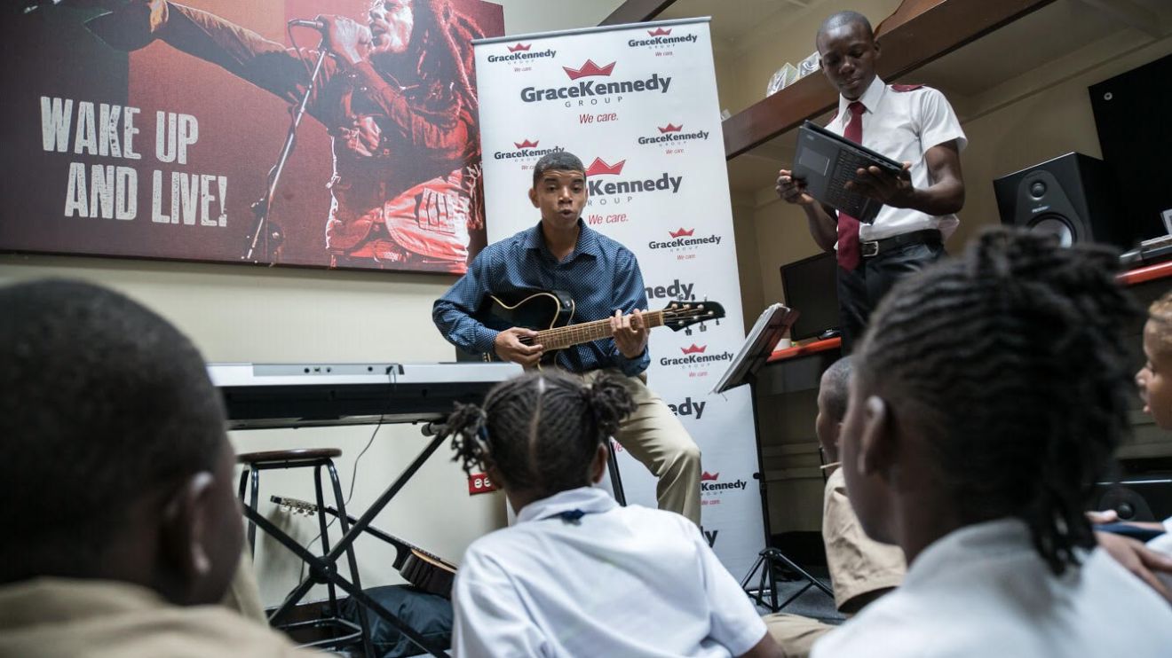 Children sitting down and enjoying some music