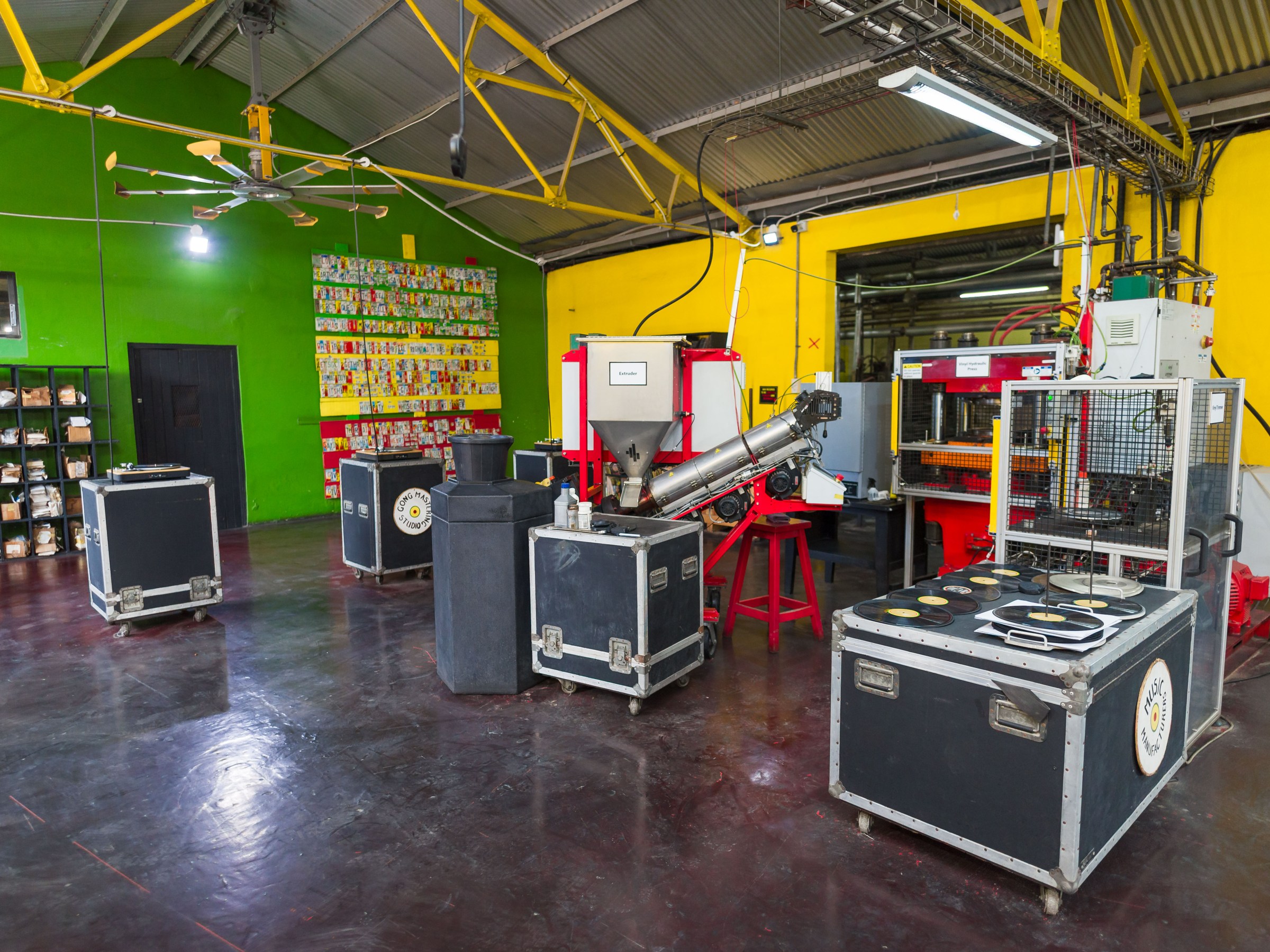 Colorful factory interior with machinery and storage cases.