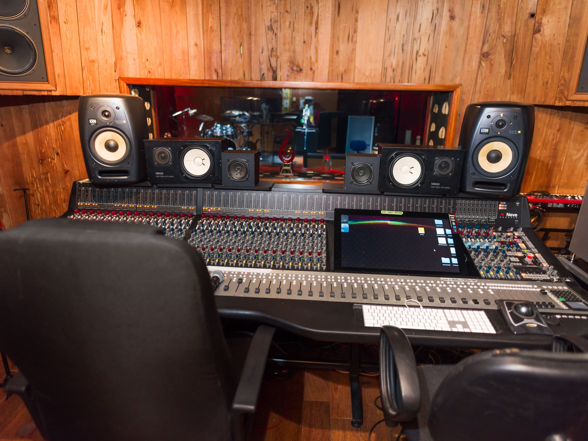 Professional recording studio with mixing console and speakers.